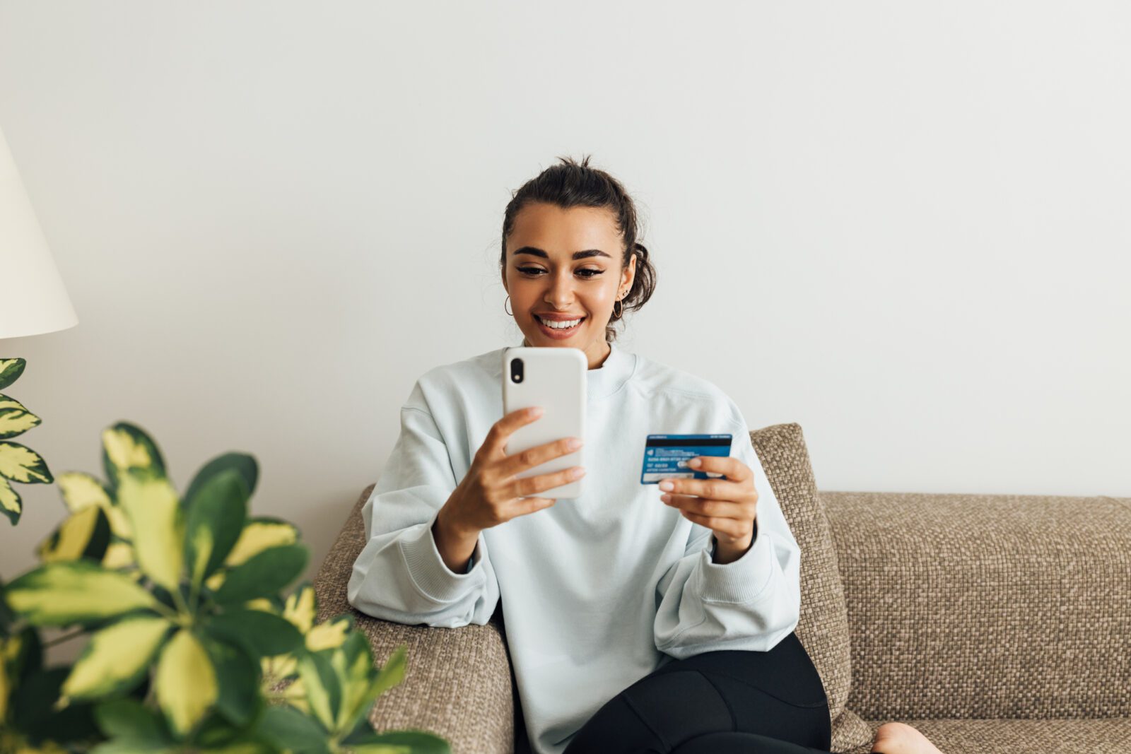 Woman doing online checkout with mobile device